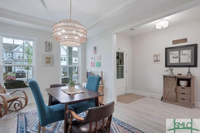 710 Longleaf Dr, Richmond Hill, GA 31324 - dining area featuring a chandelier, light wood finished floors, and baseboards