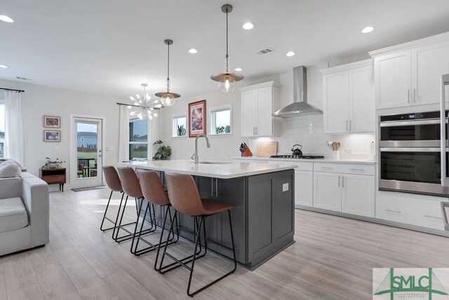 710 Longleaf Dr, Richmond Hill, GA 31324 - kitchen with wall chimney range hood, a sink, double oven, healthy amount of natural light, and recessed lighting