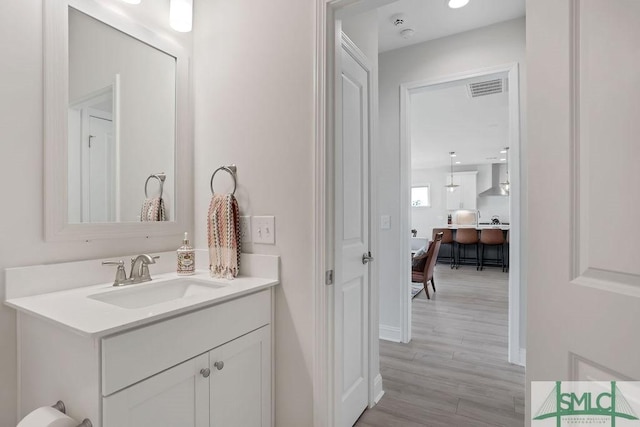710 Longleaf Dr, Richmond Hill, GA 31324 - bathroom with vanity, wood finished floors, and baseboards