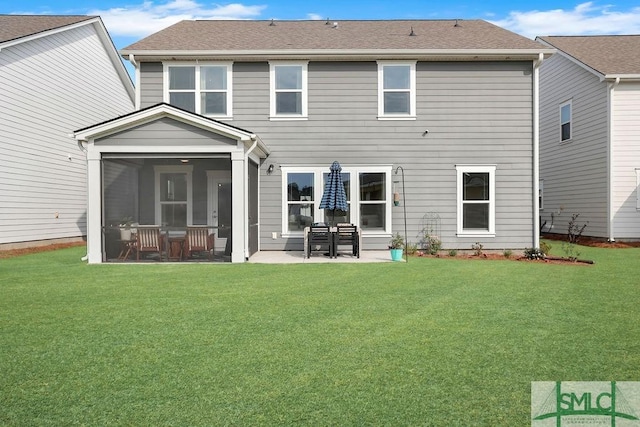 710 Longleaf Dr, Richmond Hill, GA 31324 - rear view of house with a sunroom, a yard, a patio, and a shingled roof