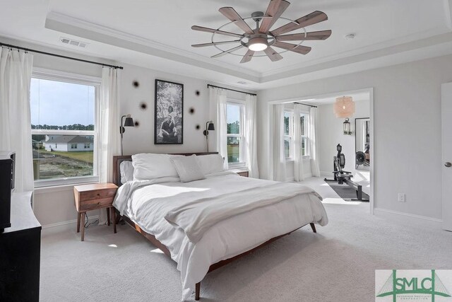 710 Longleaf Dr, Richmond Hill, GA 31324 - bedroom featuring a tray ceiling, light carpet, ornamental molding, baseboards, and a ceiling fan