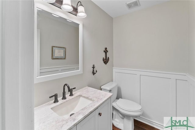 6 Baysprings Pt, Savannah, GA 31405 - bathroom featuring toilet, vanity, a wainscoted wall, and wood finished floors