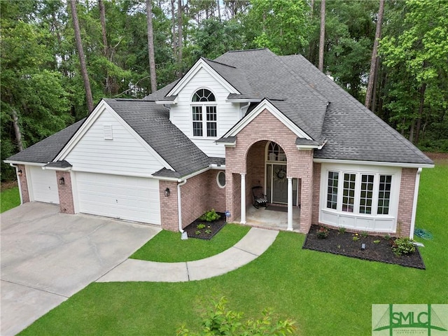 6 Baysprings Pt, Savannah, GA 31405 - traditional home with brick siding, an attached garage, concrete driveway, and a front lawn