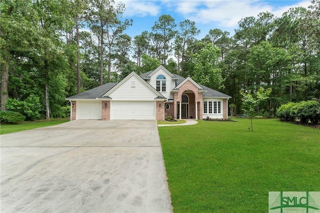 6 Baysprings Pt, Savannah, GA 31405 - view of front facade with brick siding, driveway, a front yard, an attached garage, and view of wooded area