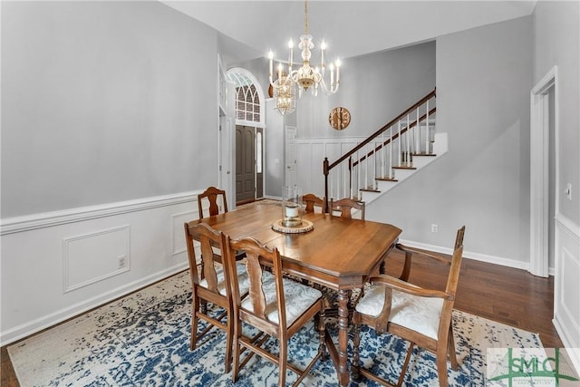 6 Baysprings Pt, Savannah, GA 31405 - dining area featuring a chandelier, wood finished floors, stairs, a decorative wall, and a wainscoted wall