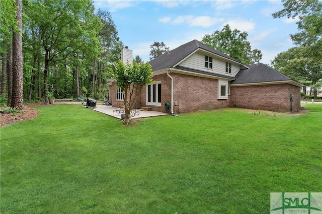 6 Baysprings Pt, Savannah, GA 31405 - rear view of house featuring a chimney, brick siding, a yard, a patio area, and french doors