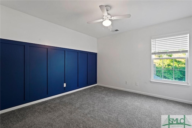 spare room with carpet floors and ceiling fan