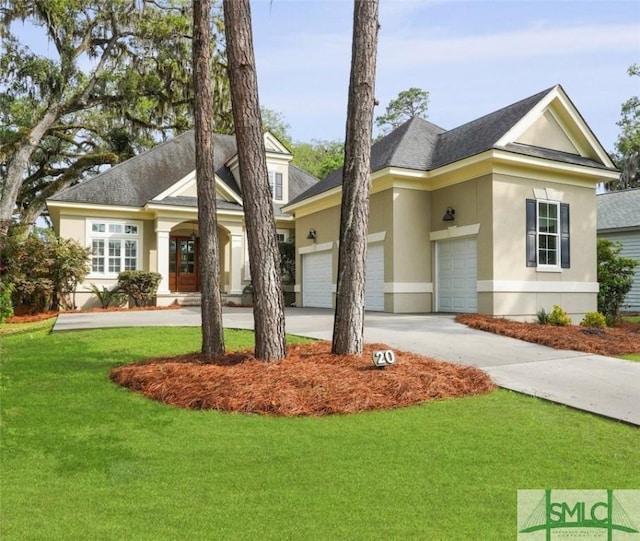 view of front of home featuring stucco siding, a front yard, driveway, a shingled roof, and a garage