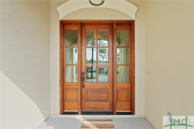 entrance to property featuring stucco siding