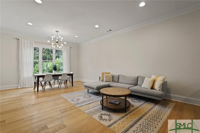 living room featuring baseboards, crown molding, a chandelier, recessed lighting, and light wood-style floors