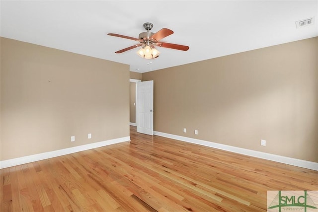 empty room with light wood-style flooring, baseboards, and ceiling fan
