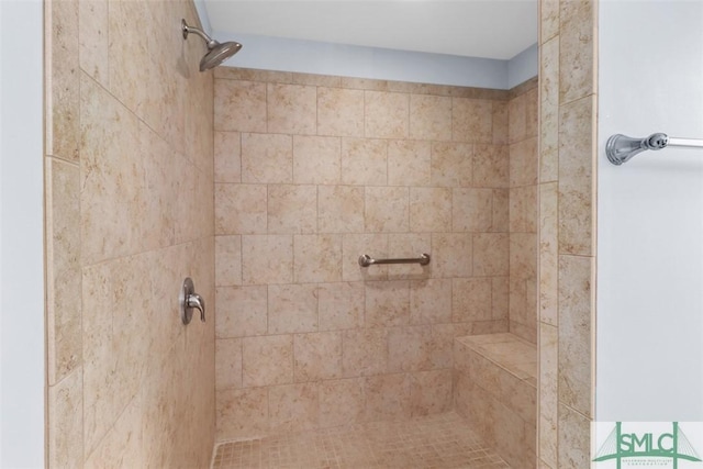 full bath with a tile shower