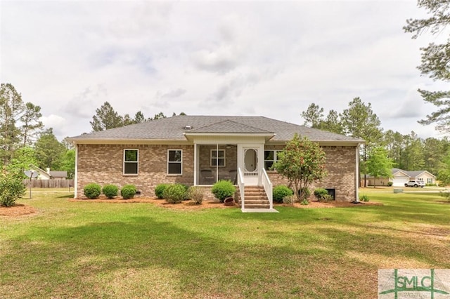 rear view of property featuring a yard, brick siding, a sunroom, and crawl space