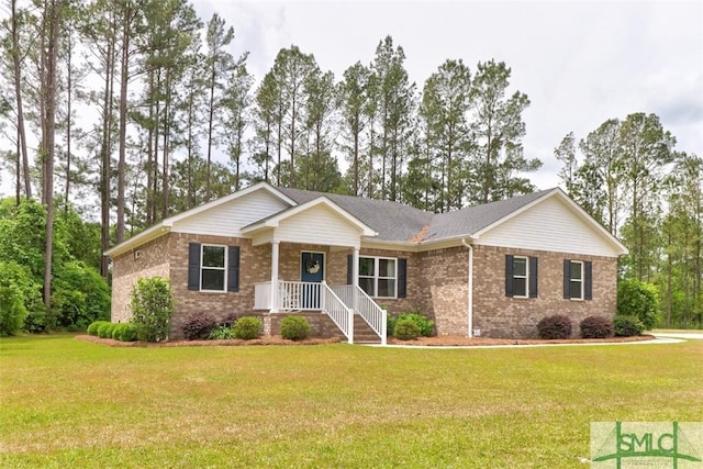 ranch-style house featuring brick siding, a front lawn, and a porch