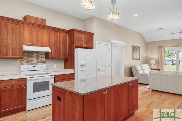 kitchen with white appliances, under cabinet range hood, open floor plan, light wood finished floors, and lofted ceiling