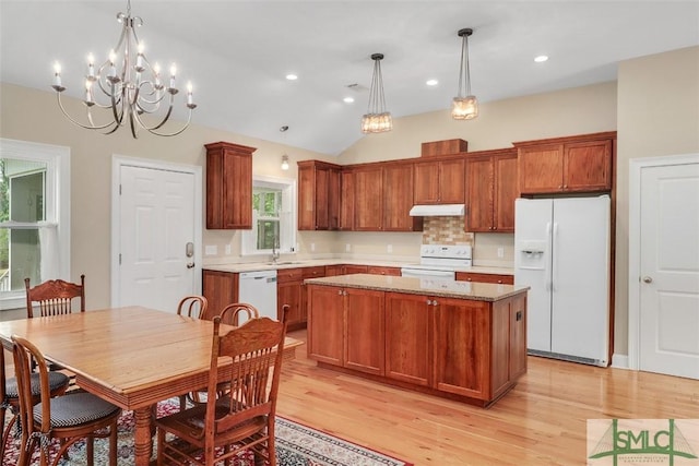 kitchen with white appliances, under cabinet range hood, a sink, a center island, and light wood-style floors
