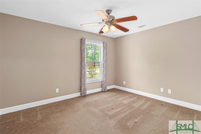 spare room featuring carpet flooring, a ceiling fan, and baseboards