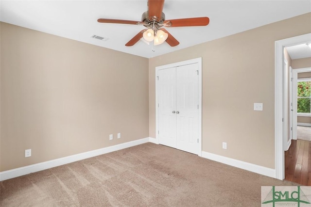 unfurnished bedroom with baseboards, a closet, and carpet