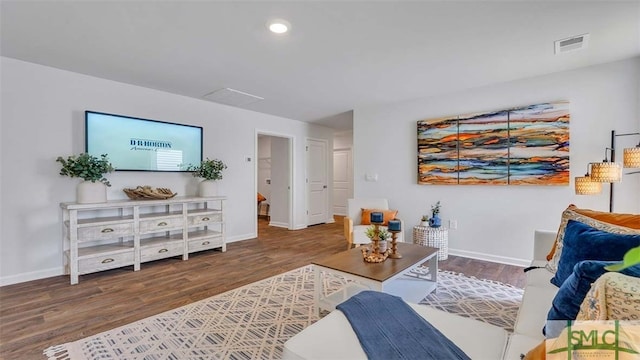 living room featuring wood finished floors, baseboards, and recessed lighting