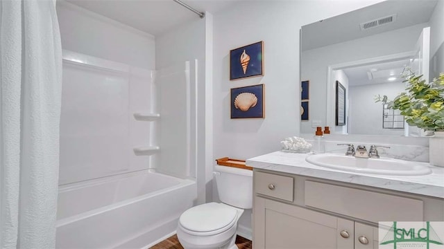 bathroom with toilet, vanity, shower / tub combo, and wood finished floors