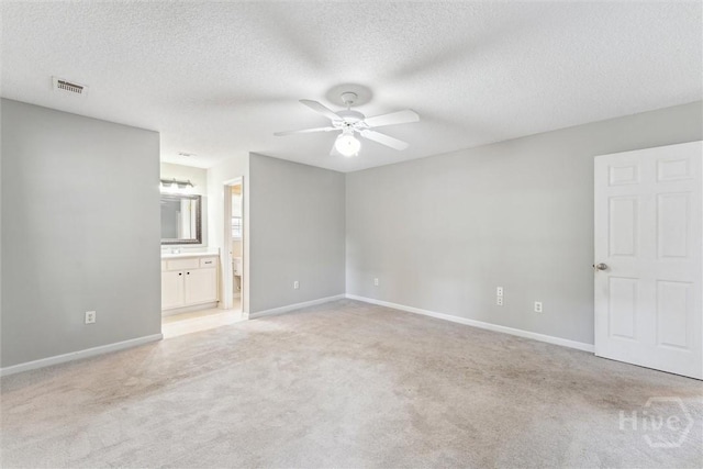 105 Mustang Dr, Guyton, GA 31312 - unfurnished bedroom featuring light colored carpet, baseboards, a textured ceiling, and ensuite bathroom