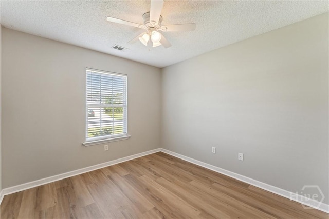 105 Mustang Dr, Guyton, GA 31312 - empty room featuring wood finished floors, baseboards, ceiling fan, and a textured ceiling