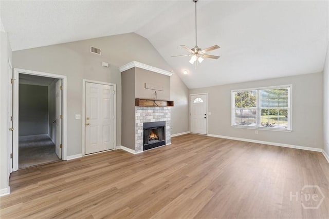 105 Mustang Dr, Guyton, GA 31312 - unfurnished living room with ceiling fan, light wood finished floors, baseboards, a brick fireplace, and high vaulted ceiling