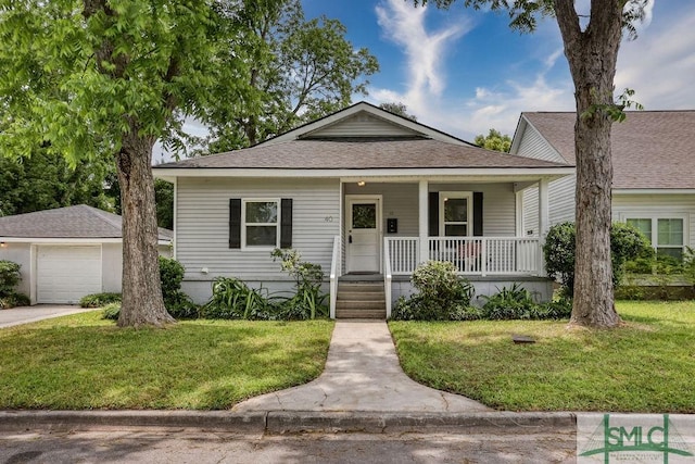 40 Lawton Ave, Savannah, GA 31404 - bungalow featuring covered porch, a front lawn, and a shingled roof