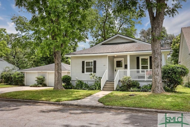 40 Lawton Ave, Savannah, GA 31404 - bungalow featuring a porch, a front yard, roof with shingles, driveway, and a garage