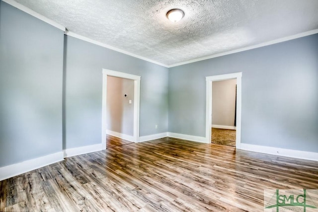40 Lawton Ave, Savannah, GA 31404 - spare room featuring crown molding, a textured ceiling, wood finished floors, and baseboards