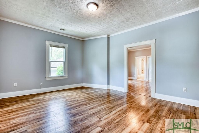 40 Lawton Ave, Savannah, GA 31404 - empty room with a textured ceiling, ornamental molding, wood finished floors, and baseboards