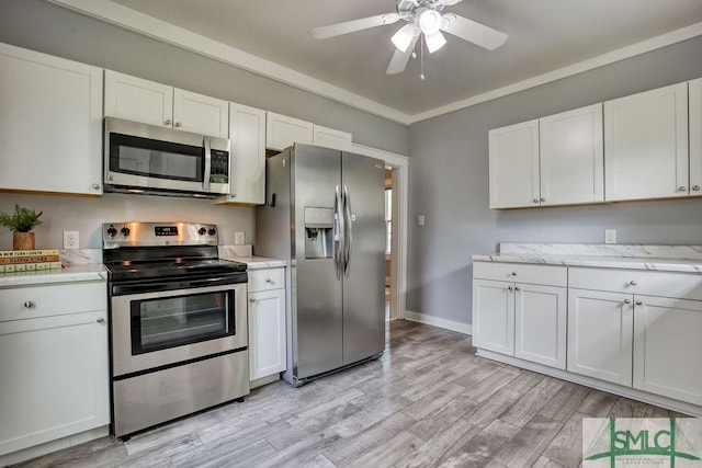 40 Lawton Ave, Savannah, GA 31404 - kitchen featuring stainless steel appliances, ceiling fan, white cabinetry, light wood-style flooring, and baseboards