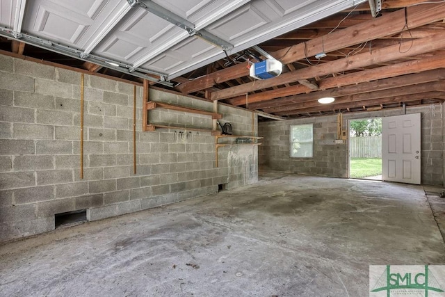 40 Lawton Ave, Savannah, GA 31404 - garage featuring a garage door opener and concrete block wall