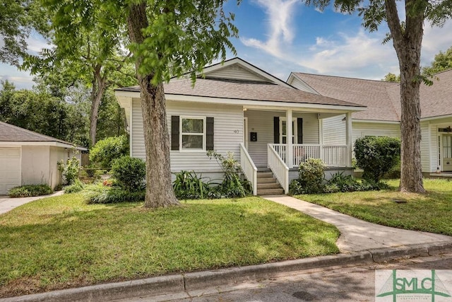 40 Lawton Ave, Savannah, GA 31404 - bungalow-style home featuring covered porch, a front yard, and roof with shingles