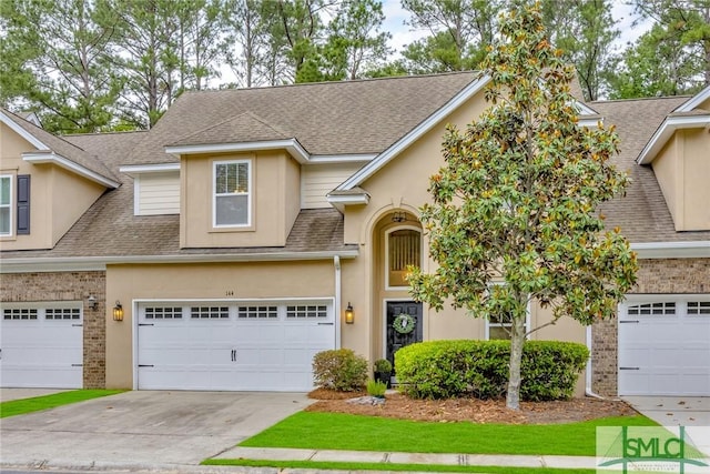 144 Royal Ln, Pooler, GA 31322 - traditional-style house with driveway, a shingled roof, stucco siding, brick siding, and a garage