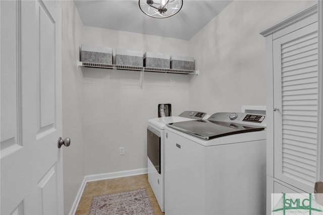 144 Royal Ln, Pooler, GA 31322 - clothes washing area featuring washing machine and dryer, baseboards, and light tile patterned floors
