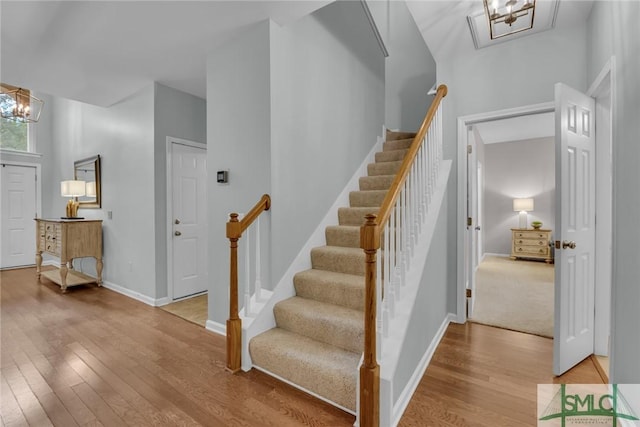 144 Royal Ln, Pooler, GA 31322 - staircase featuring a chandelier, wood finished floors, and baseboards