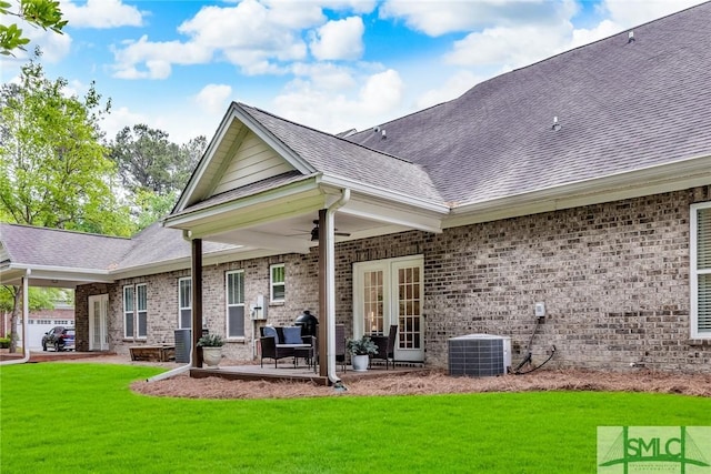 144 Royal Ln, Pooler, GA 31322 - back of house with brick siding, a lawn, a shingled roof, and ceiling fan