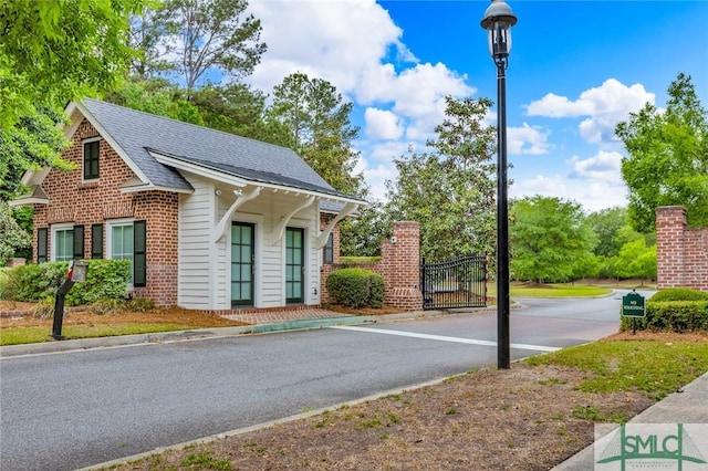 144 Royal Ln, Pooler, GA 31322 - view of asphalt street featuring street lights, curbs, and a gate