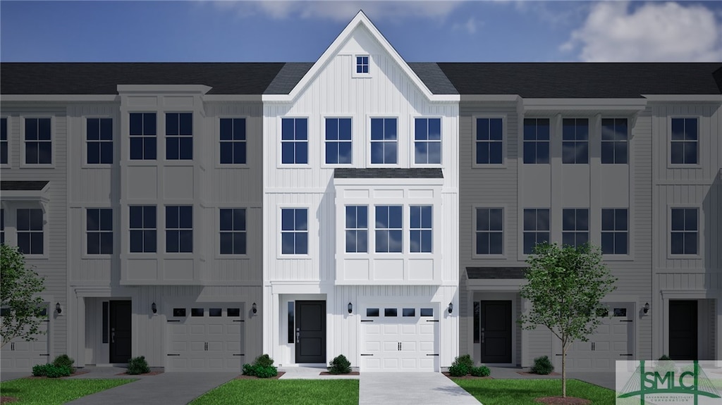 townhome / multi-family property featuring board and batten siding and a garage