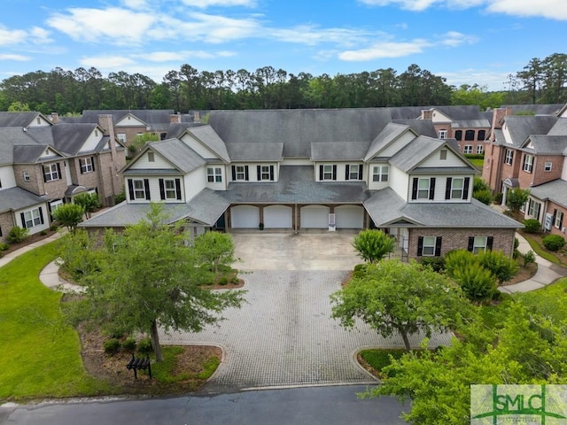 1104 River Oaks Dr Unit 1104, Richmond Hill, GA 31324 - view of front of home featuring driveway, an attached garage, a residential view, and stucco siding