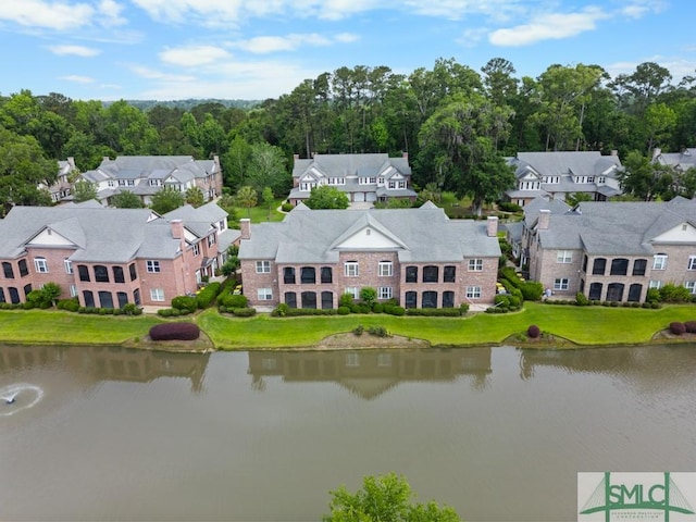 aerial view of residential area featuring a large body of water