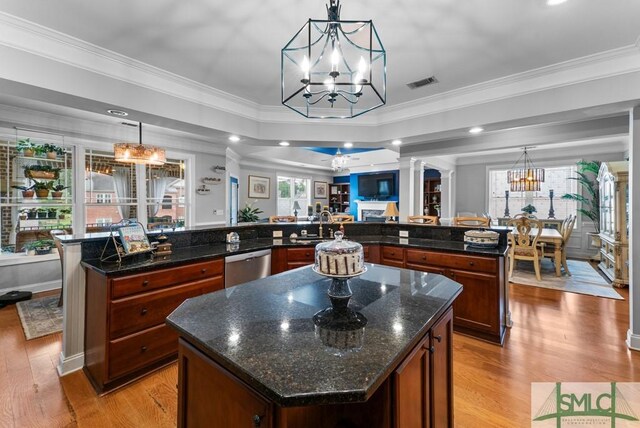 1104 River Oaks Dr Unit 1104, Richmond Hill, GA 31324 - kitchen featuring a large island, a chandelier, stainless steel dishwasher, light wood-type flooring, and ornate columns
