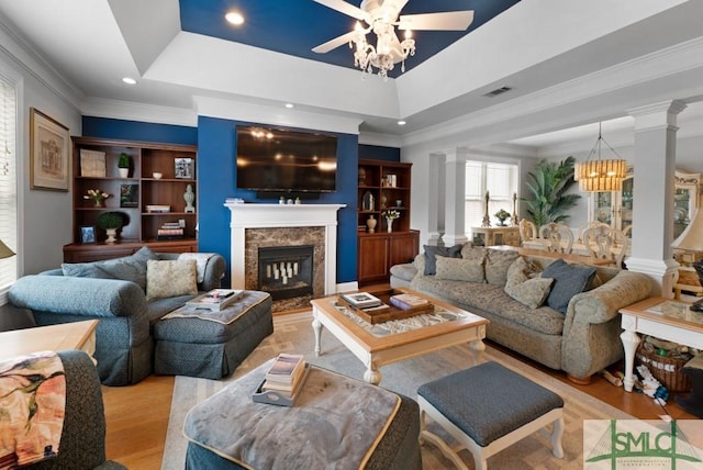 1104 River Oaks Dr Unit 1104, Richmond Hill, GA 31324 - living area featuring ceiling fan, light wood-style flooring, crown molding, a tray ceiling, and a high end fireplace