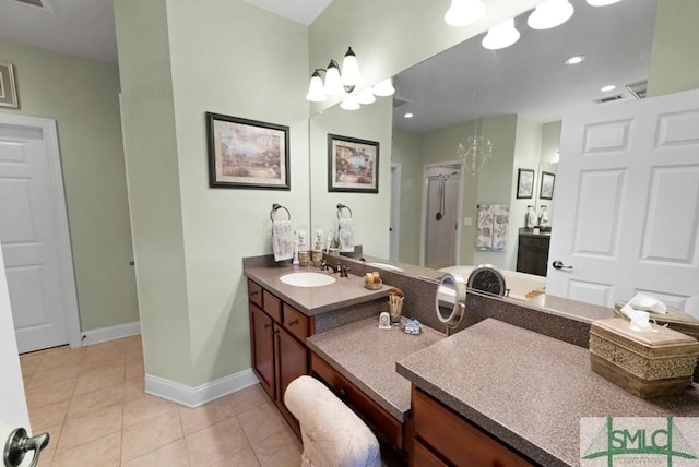 bathroom featuring tile patterned flooring, baseboards, vanity, recessed lighting, and a stall shower