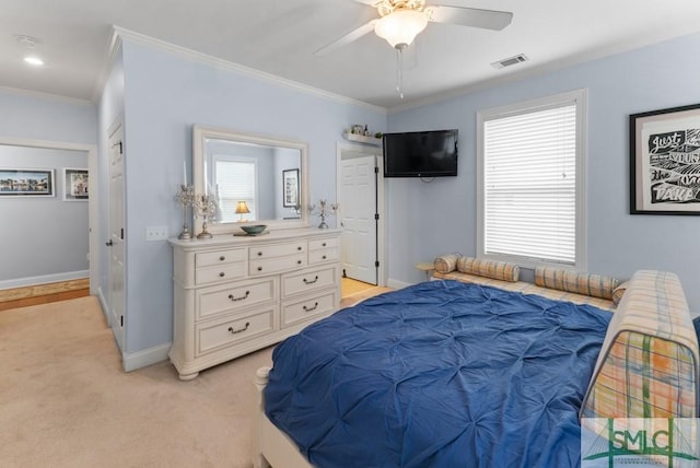 bedroom featuring crown molding, baseboards, light colored carpet, and a ceiling fan
