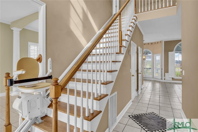 105 Crooked Wood Ln, Savannah, GA 31406 - stairway with tile patterned floors, baseboards, decorative columns, arched walkways, and a high ceiling