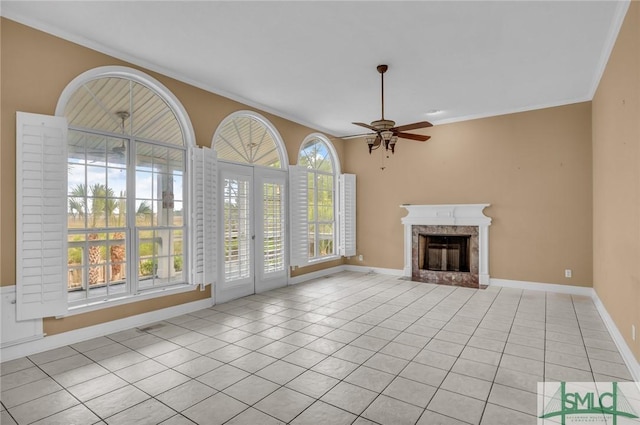 105 Crooked Wood Ln, Savannah, GA 31406 - unfurnished living room with light tile patterned flooring, a ceiling fan, a premium fireplace, ornamental molding, and baseboards