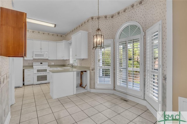 105 Crooked Wood Ln, Savannah, GA 31406 - kitchen featuring white appliances, wallpapered walls, a chandelier, light countertops, and a peninsula