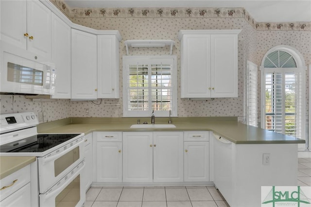 105 Crooked Wood Ln, Savannah, GA 31406 - kitchen featuring wallpapered walls, white appliances, a sink, a peninsula, and light tile patterned flooring